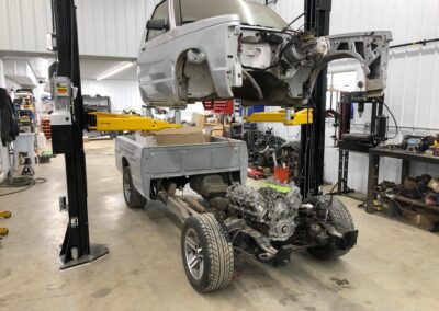 A car being lifted on a garage lift.